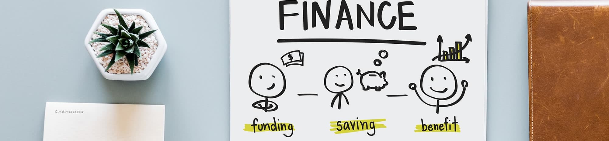 A desk with a notepad sketch of funding, saving and benefit beside a plant
